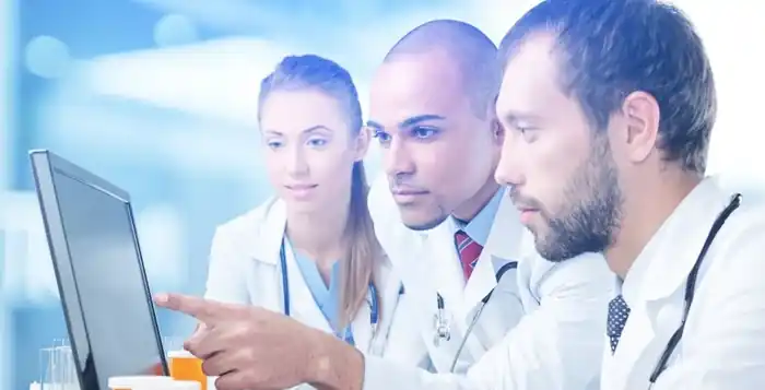 Healthcare professionals reviewing a monitor